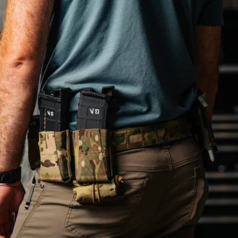 Low-profile dump pouch folded and secured on a first-line belt to remain compact and snag-free until needed